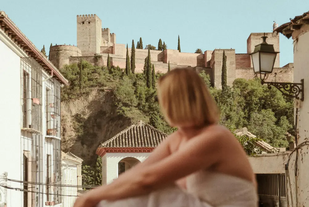 Woman admiring the Alhambra of Granada